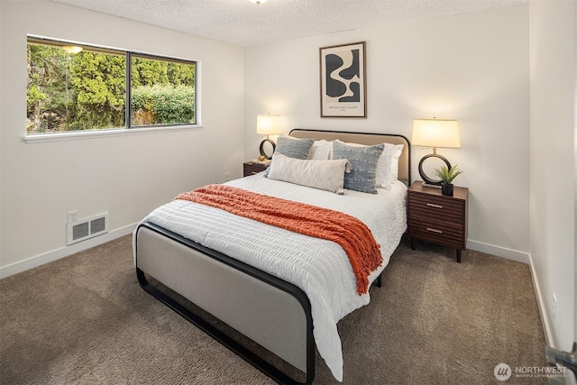 carpeted bedroom featuring visible vents, a textured ceiling, and baseboards