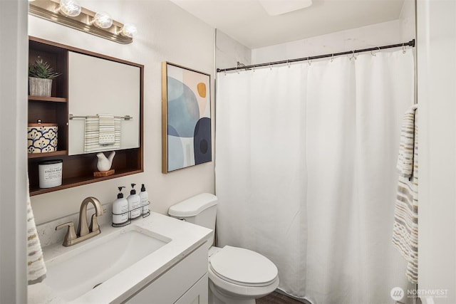 full bathroom with vanity, a shower with shower curtain, and toilet