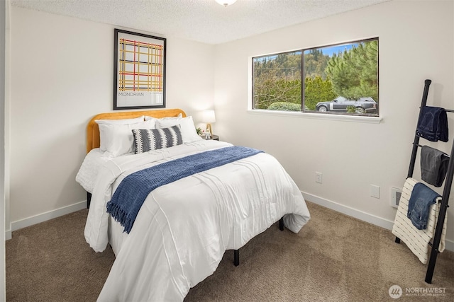 carpeted bedroom with a textured ceiling and baseboards