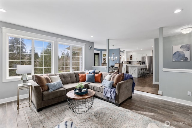 living area featuring recessed lighting, baseboards, and wood finished floors