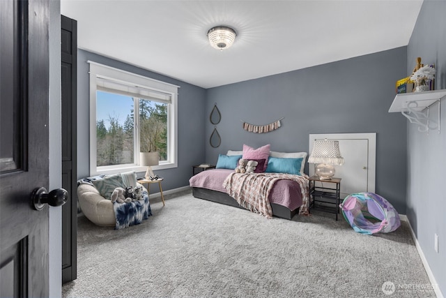 carpeted bedroom featuring baseboards