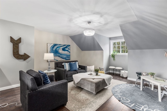 living room with baseboards, a notable chandelier, wood finished floors, and vaulted ceiling