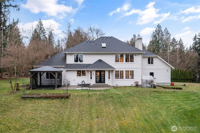 back of house with a gazebo, french doors, a yard, and a chimney