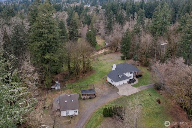 birds eye view of property with a forest view