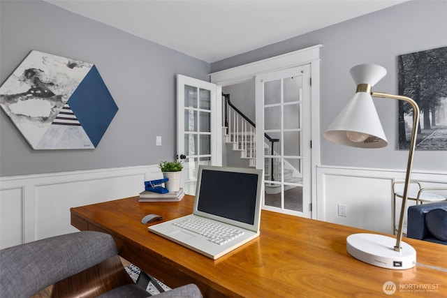 home office featuring a decorative wall and wainscoting