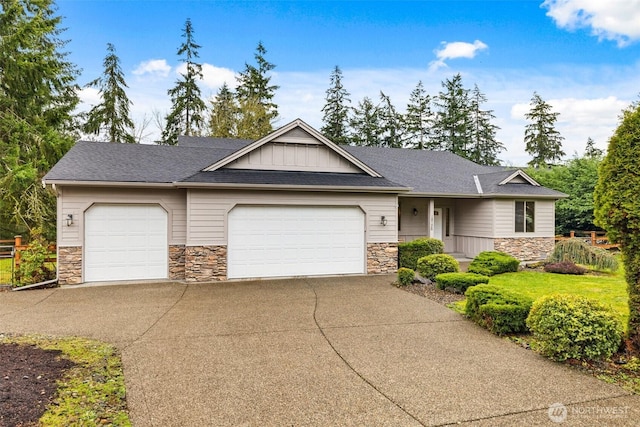 view of front facade featuring board and batten siding, concrete driveway, a garage, and stone siding