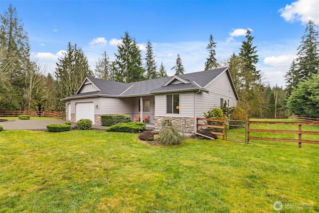 ranch-style house featuring fence, a front yard, a garage, stone siding, and driveway