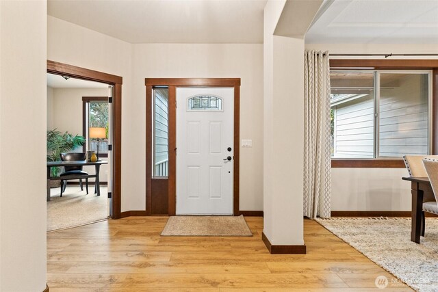 entryway featuring light wood-style flooring and baseboards