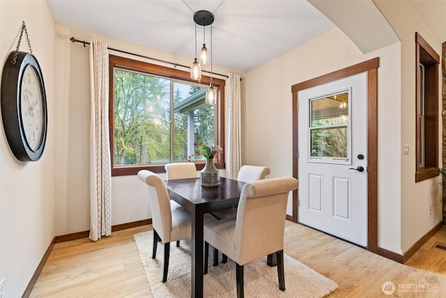 dining room featuring visible vents, baseboards, and light wood-style floors