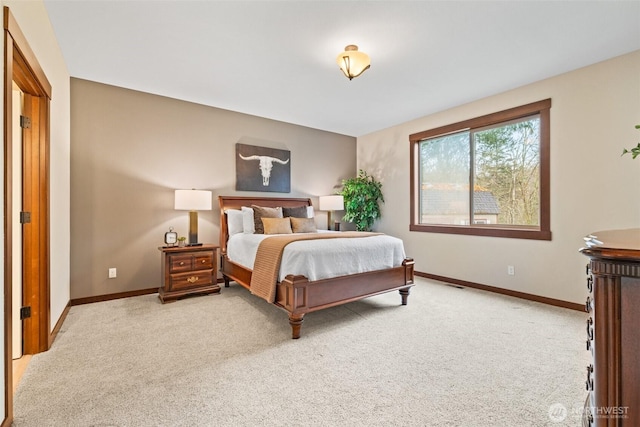 bedroom featuring baseboards and light carpet