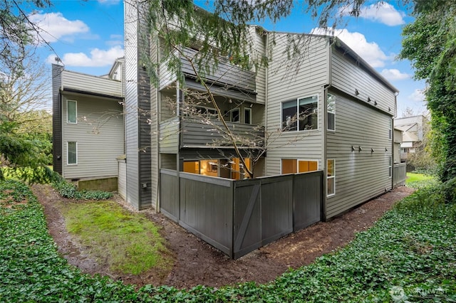 back of property with a chimney