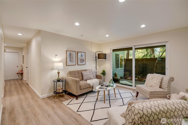 living area with recessed lighting, baseboards, and light wood finished floors