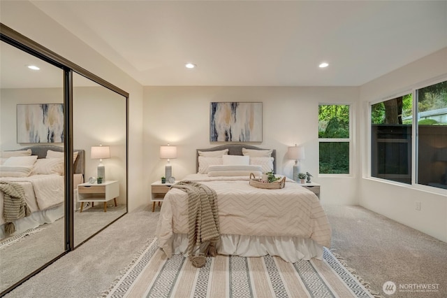 carpeted bedroom featuring recessed lighting and a closet