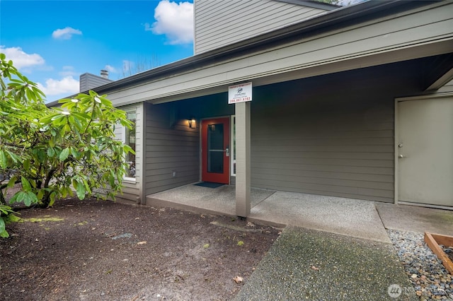 doorway to property with a chimney