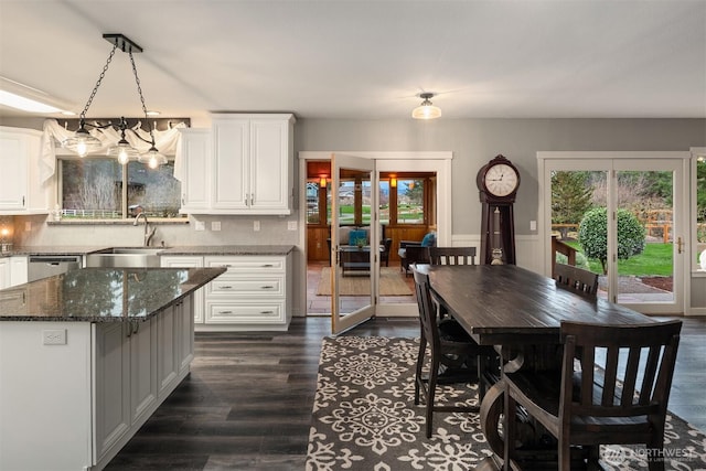 dining area featuring a healthy amount of sunlight and dark wood finished floors