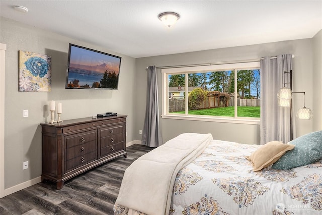 bedroom featuring dark wood-type flooring and baseboards