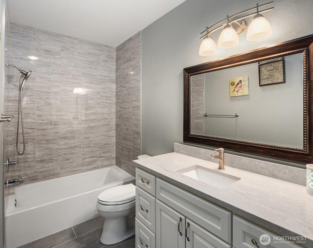 full bathroom featuring tile patterned floors, toilet, bathtub / shower combination, and vanity