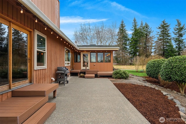 view of patio / terrace featuring a wooden deck and a grill