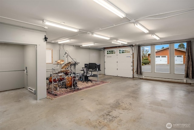 garage featuring a baseboard radiator and a baseboard heating unit