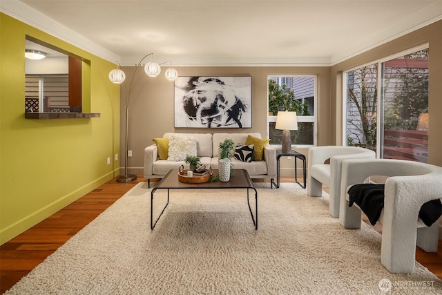 living area with baseboards and wood finished floors