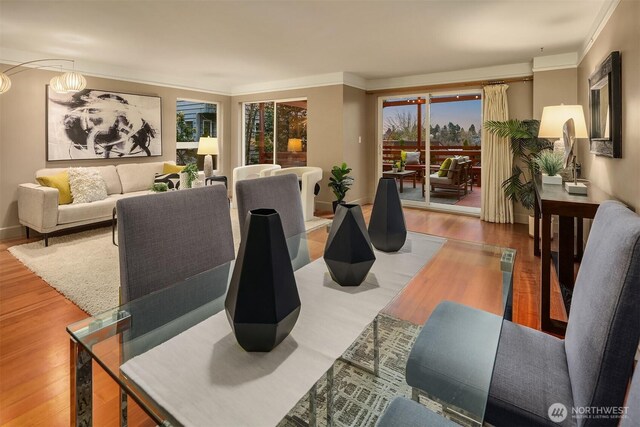 living area featuring wood finished floors and ornamental molding