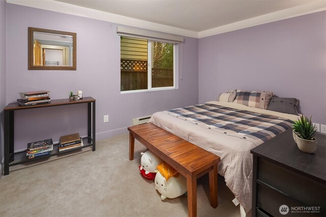 bedroom with baseboards, carpet floors, baseboard heating, and ornamental molding