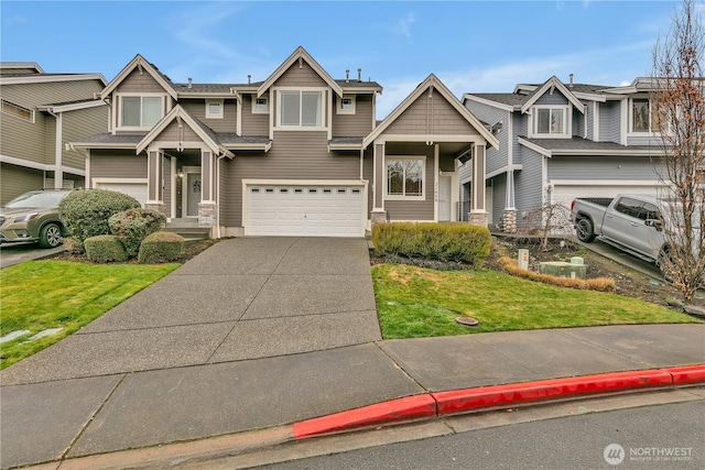 view of front of house featuring a front lawn, a garage, and driveway