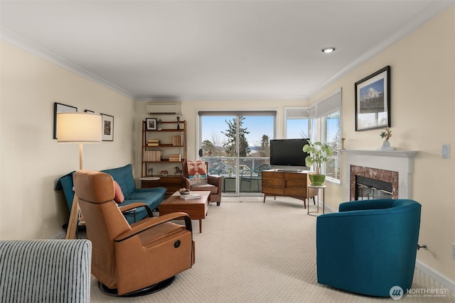 living room with baseboards, carpet floors, a premium fireplace, an AC wall unit, and crown molding