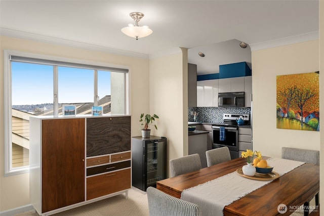 dining room with beverage cooler, light carpet, and ornamental molding