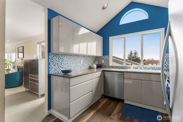 kitchen featuring backsplash, dishwasher, white refrigerator with ice dispenser, white cabinets, and a sink