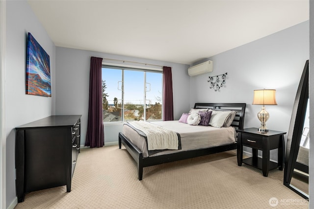 bedroom featuring baseboards, a wall mounted air conditioner, and light carpet