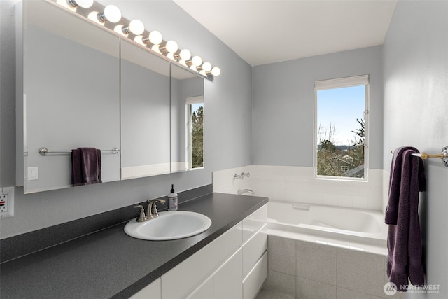 bathroom featuring vanity and a garden tub