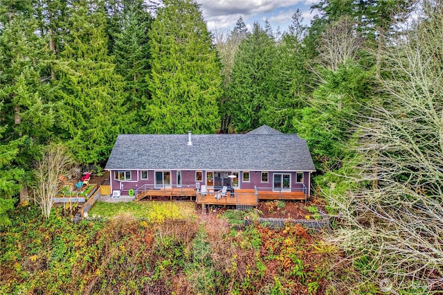 view of front of home featuring a shingled roof and a deck