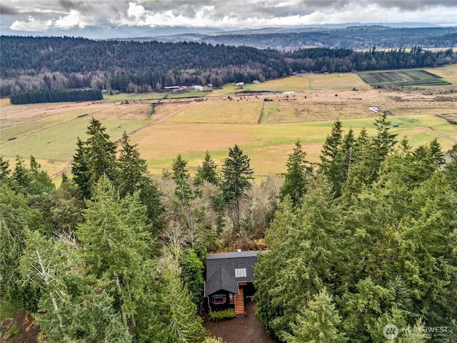 drone / aerial view featuring a rural view and a view of trees