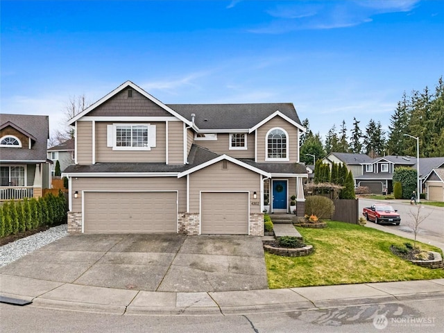 view of front of home with a front yard, a garage, and driveway