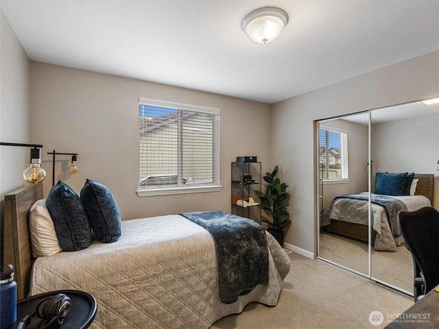 bedroom with multiple windows, carpet flooring, baseboards, and a closet