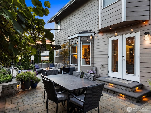 view of patio featuring an outdoor living space with a fire pit, outdoor dining space, and french doors