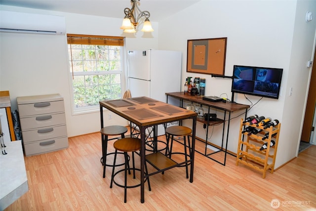 610 N Duckabush Dr N, Hoodsport, WA 98548 - dining space featuring a chandelier, light wood-type flooring, and a wall unit AC