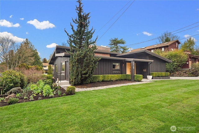 mid-century home with board and batten siding and a front lawn