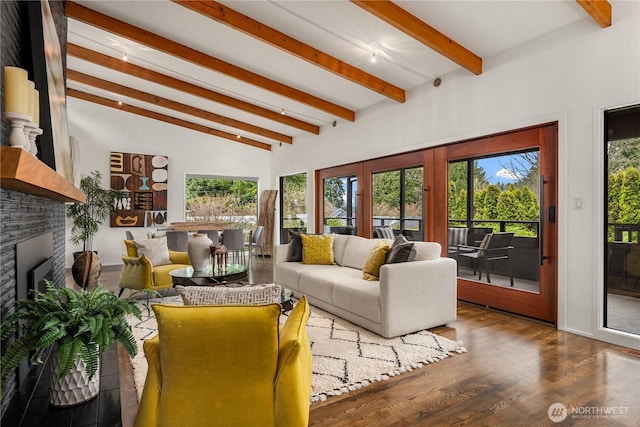 living area with beamed ceiling, wood finished floors, and a fireplace