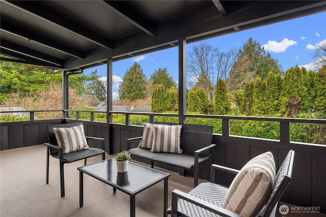 sunroom / solarium with beam ceiling and a healthy amount of sunlight