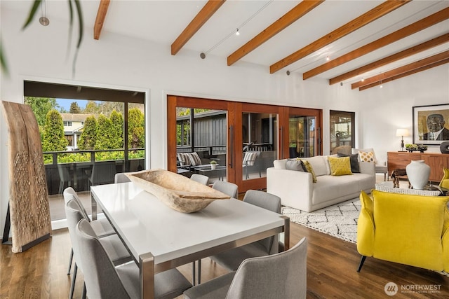 dining area featuring beam ceiling and wood finished floors