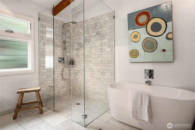 bathroom with tile patterned floors, beamed ceiling, a shower stall, baseboards, and a freestanding bath