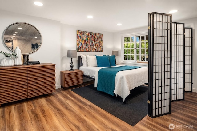 bedroom featuring recessed lighting, baseboards, and wood finished floors