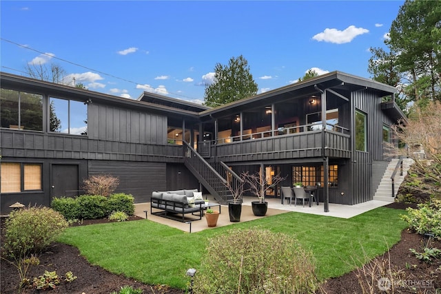 back of house with an outdoor living space, stairway, a yard, and a patio area