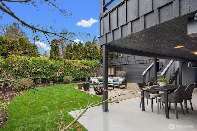 view of yard with a patio area, outdoor dining space, outdoor lounge area, and stairs