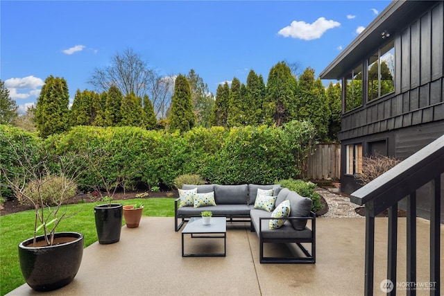 view of patio / terrace featuring an outdoor living space and fence