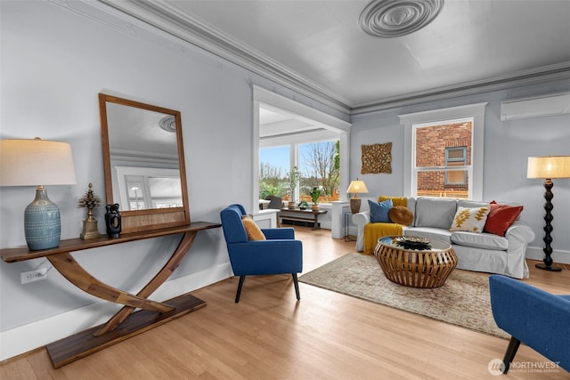 living room featuring baseboards, wood finished floors, a wall unit AC, and ornamental molding