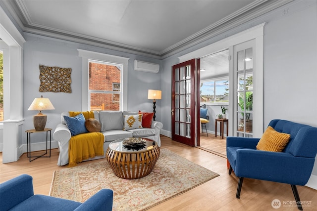 living room featuring wood finished floors, an AC wall unit, and ornamental molding