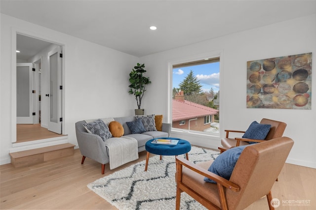 living area with recessed lighting and wood finished floors